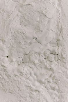 Detailed close-up of white cracked plaster texture, ideal for backgrounds.